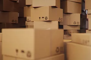 Piles of brown cardboard boxes stacked messily in a pile