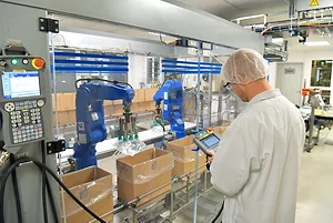 A WORKER OPERATES MACHINERY AT A MEDICAL PRODUCTS MANUFACTURING FACILITY.