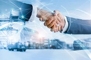 A close-up of two hands shaking, set against a blue-tinted background showing shipping cranes, containers, and trucks