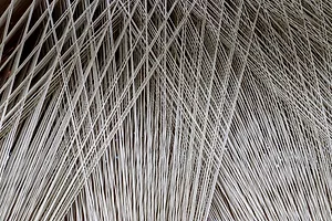 Close up texture of a lot of threads in a weaving machine called a loom